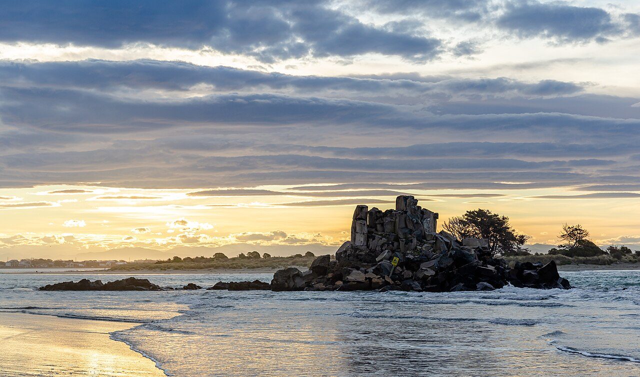 Sunset over Rapanui Rock at Sumner, New Zealand