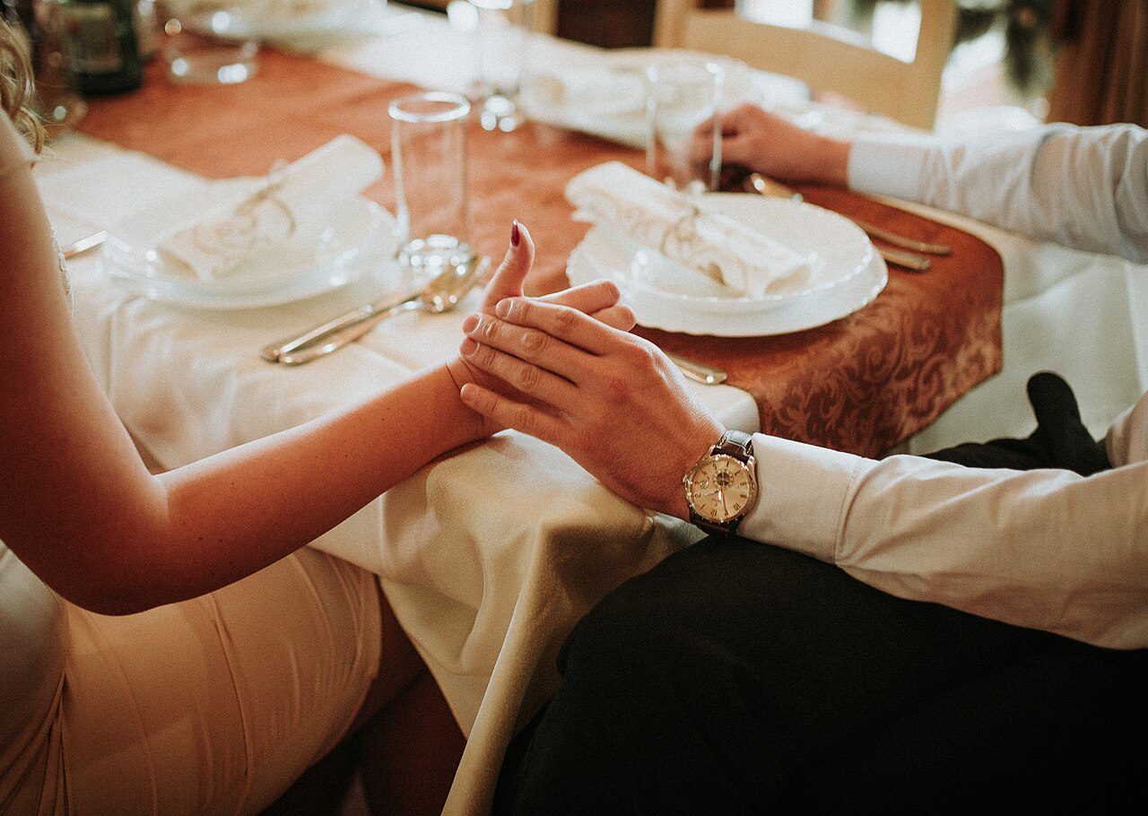 A wedding couple holding hands, close up